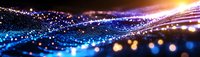 Glowing blue and gold light particles flow across dark background creating dynamic wave effect with bokeh and motion blur for technology backgrounds.