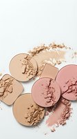 Broken makeup powder compacts in nude and pink shades scattered on white background for beauty and cosmetics branding.