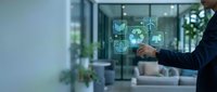 Businessman in dark suit touching digital sustainability icons including recycling symbol and wind turbine on transparent screen in modern office environment with green plants.