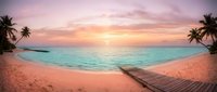 Serene tropical beach at sunset with wooden dock, turquoise water, golden sky, and palm trees framing sandy shore for travel and vacation concepts.
