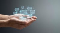 Digital blockchain network floating above open hands with glowing cryptocurrency blocks and data connections for fintech and technology concepts.