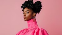 Young African American woman with natural hair in space buns wearing vibrant pink high-neck dress against pink background, fashion portrait showcasing modern style and confidence.