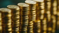 Stacked golden coins in rows creating financial pattern with selective focus, symbolizing wealth, investment and economic growth.