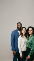 Three diverse professionals smiling together against neutral background. African American man wearing blue blazer, Asian woman in cream sweater, and Latina woman in green shirt. Studio portrait for corporate, team, diversity, and business communications.