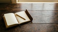Open notebook with blank pages and pencil on rustic wooden table, ready for writing, planning, journaling, education, or creative work projects.