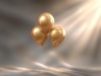 Elegant golden balloons floating against soft gray background with dramatic light rays creating luxurious atmosphere for celebration and special events.