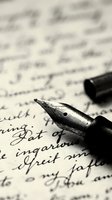 Vintage fountain pen with metal nib resting on handwritten manuscript page, shallow depth of field capturing calligraphy and cursive script for writing, literature, and correspondence concepts.