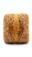 Artisan multigrain bread loaf with mixed seeds and grains isolated on white background for bakery and healthy food concepts.