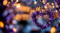 Heart shaped wreath made of purple flowers hanging against blurred warm bokeh lights background creates romantic Valentine's day or wedding atmosphere.