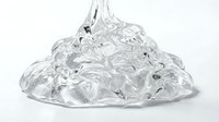 Clear gel or slime substance with glossy, translucent texture isolated on white background. Suitable for cosmetics, skincare, beauty product packaging, and design applications.