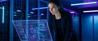 Young Asian woman software engineer analyzing holographic data visualization in modern server room with neon lighting for technology presentations.