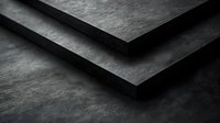 Dark layered stone or concrete surfaces creating geometric shadows and depth effect, minimalist architectural detail with dramatic lighting and textured finish.