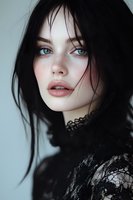 Young woman with striking blue eyes, freckles and dark hair wearing black lace, looking directly at camera with parted lips against light background.