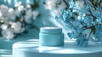 Luxurious face cream jar on white surface with delicate spring flowers in soft turquoise blue tones, creating elegant cosmetic composition for beauty and skincare marketing.