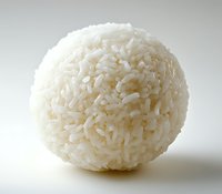 Round ball of cooked white rice shaped into a perfect sphere against light background, showcasing texture and individual grains in macro photography.