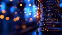 Glowing blue and orange bokeh lights create magical atmosphere with sparkling decorative elements against dark background, festive holiday mood.