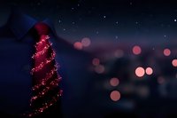 Elegant red necktie with glowing spiral pattern against blurred night cityscape with bokeh lights, perfect for formal event promotions.