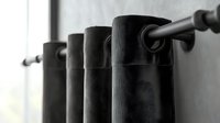 Black curtain rings on metal rod against white wall, creating minimalist pattern with dramatic shadows and depth. Modern window treatment detail in monochrome style.