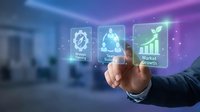 Businessman hand touching digital interface with glowing holographic icons representing settings, artificial intelligence, and market growth analytics in modern office environment.