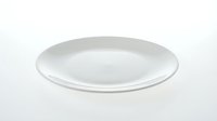 Empty white ceramic plate isolated on light background, suitable for food photography, restaurant menus, and tableware design projects.