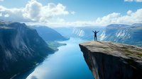 Silhouette of person with raised arms standing on cliff edge overlooking dramatic fjord landscape with blue water, mountains and clouds in summer season.