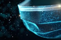 Glowing blue particles and light waves creating dynamic motion effect against dark background, abstract technological or scientific visualization.