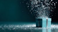 Elegant turquoise gift box with sparkling silver particles floating upward against dark background, creating magical holiday atmosphere.