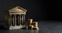 Classical bank building with golden coin stacks representing financial growth, investment returns and monetary success in banking sector.