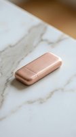 Rose gold USB flash drive on white marble surface for modern tech storage and data transfer needs.