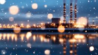 Industrial power plant with illuminated chimneys reflecting in water at night, bokeh snow effect creates magical winter atmosphere with glowing lights.