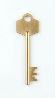 Golden brass house key isolated on white background, symbolizing security, access, and real estate ownership for property and home concepts.