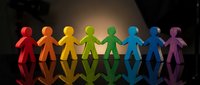 Colorful paper cutout figures holding hands in unity, representing diversity, teamwork and inclusion concepts for business presentations and social campaigns.