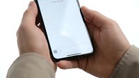 Hands holding smartphone with blank white screen isolated on white background for mobile app mockup and digital technology presentation.