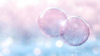Delicate soap bubbles floating against dreamy pink and blue bokeh background with sparkling light effects and soft glowing atmosphere. Suitable for romantic designs.