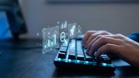 Business professional typing on keyboard with holographic data analytics charts and graphs floating above for digital transformation and financial analysis.