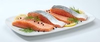 Fresh raw salmon fillets with herbs and spices on white plate, ready for cooking. Healthy seafood ingredient for gourmet meals and culinary preparation.