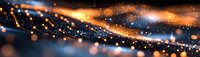 Abstract glowing particles with orange and blue light streaks creating dynamic motion effect against dark background, macro photography style panoramic view.