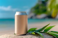 Aluminum can mockup on tropical beach sand with palm leaves and turquoise ocean background for beverage branding and packaging design projects.
