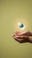 Hands holding glowing light bulb with green Earth inside, symbolizing eco-friendly innovation and sustainable energy solutions for environmental protection.