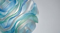 Abstract flowing blue and turquoise translucent ribbons creating elegant waves against soft gradient background for modern design projects.