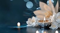 Glowing silver diya lamp with white jasmine flowers on dark blue background with bokeh lights creates serene spa and meditation atmosphere.