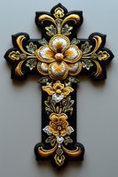 Ornate gold embroidered cross with floral motifs on black fabric, featuring intricate metallic threadwork and decorative elements for religious design projects.
