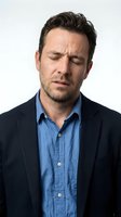 Stressed businessman with closed eyes showing fatigue and mental exhaustion isolated on white background for corporate wellness concepts.