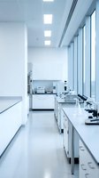 Modern sterile laboratory interior with white countertops, microscopes and scientific equipment. Clean research facility for medical testing and analysis.
