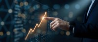 Businessman pointing at glowing upward arrow chart showing growth and success in digital business analytics with bokeh background for presentations.