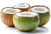 Fresh coconut halves with white meat exposed, tropical fruit bowls ready for healthy drinks and cooking on white background.