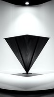 Black geometric triangular sculpture displayed on white curved platform under dramatic spotlight creating artistic shadows and modern minimalist atmosphere.