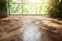 Empty room interior with herringbone parquet flooring and large window overlooking green garden. Natural sunlight creates warm atmosphere for home design.