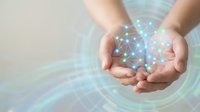 Hands holding glowing digital network sphere with connected nodes and data visualization effects for technology and innovation concepts.