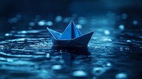 Paper boat floating on dark water surface with bokeh lights and water drops creating magical atmosphere. Artistic macro photography for creative design.